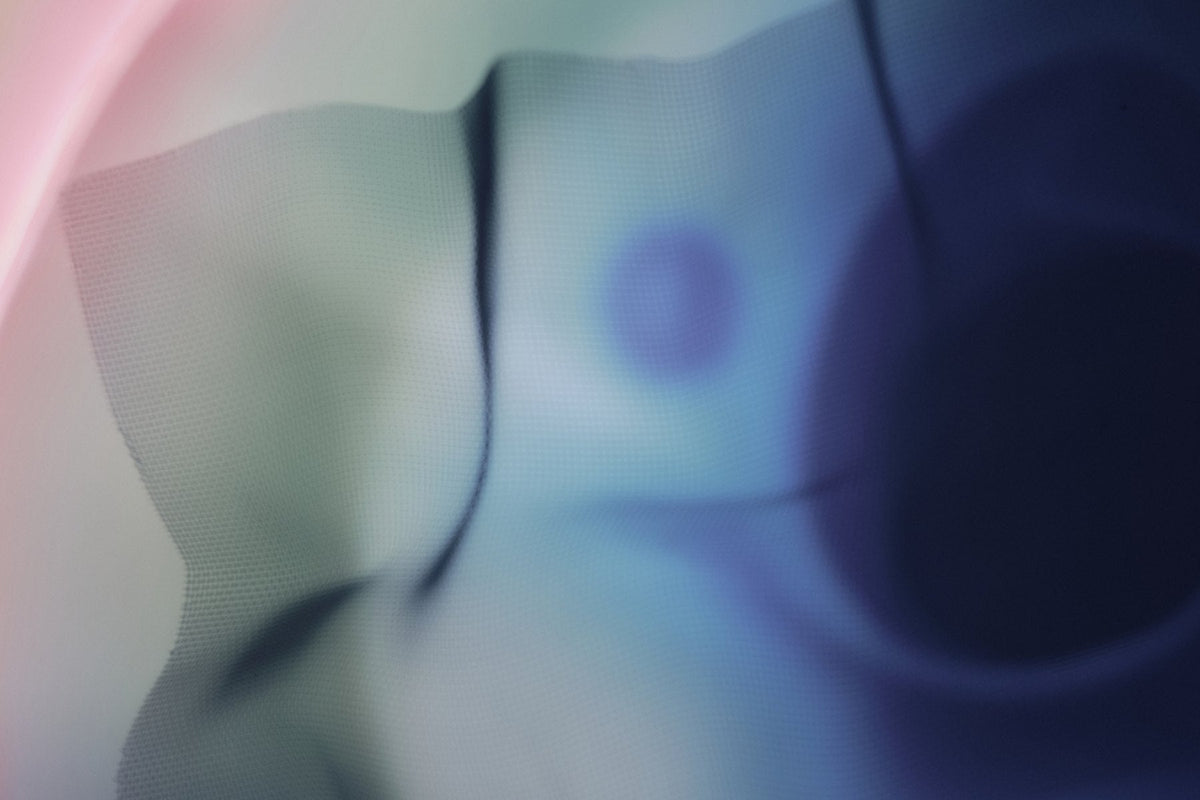 A soft pale sphere fading through blue and cream, moon-like