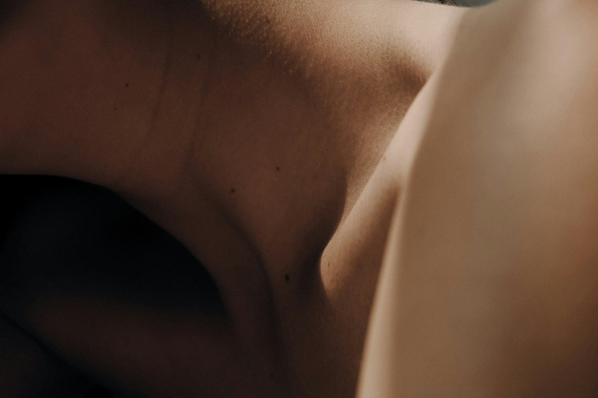 Close-up of a smooth jaw and neck in low light