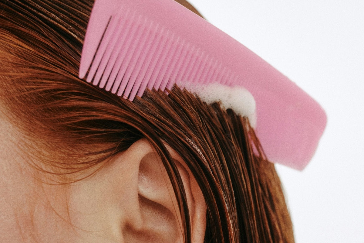 A comb drawn smoothly through long hair