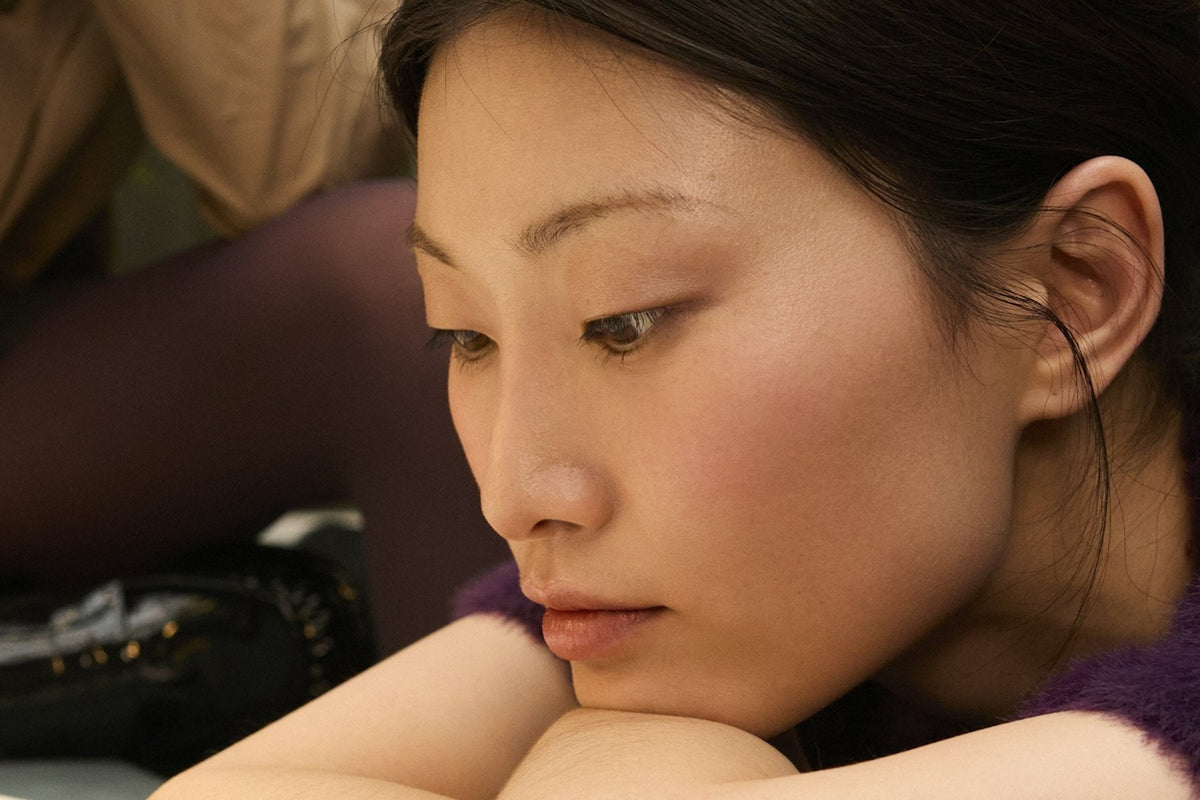 Resting with head on folded arms, calm and tired