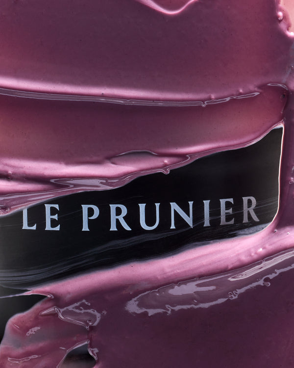 The Le Prunier logo seen through a thick layer of plum-coloured Plumtox enzyme mask | Botā natural skincare.
