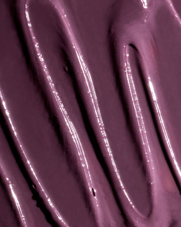 Glossy sweeps of plum-coloured Plumtox enzyme mask spread across a surface | Botā natural skincare.