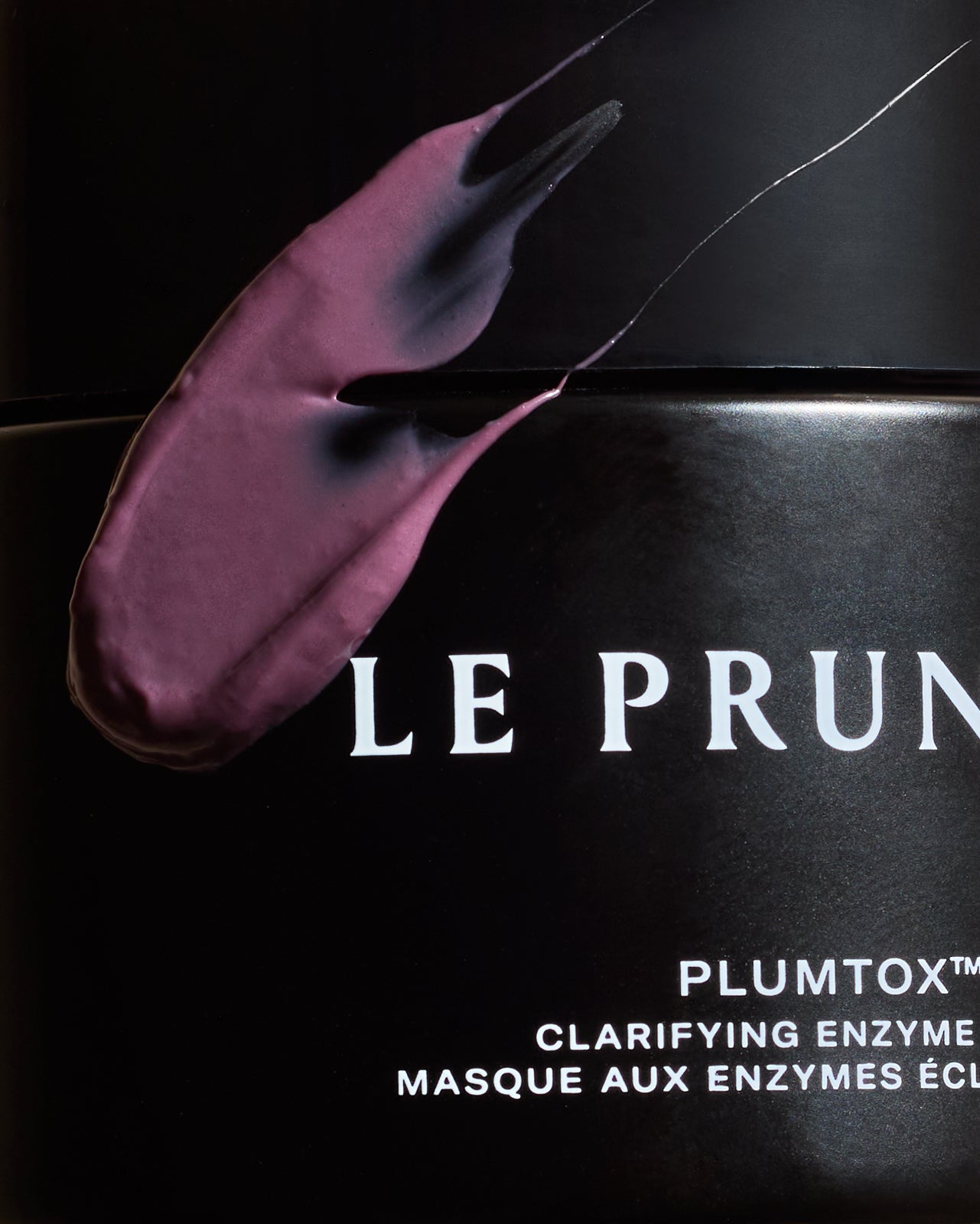 A plum-coloured smear of Plumtox enzyme mask across the black Le Prunier jar | Botā natural skincare.