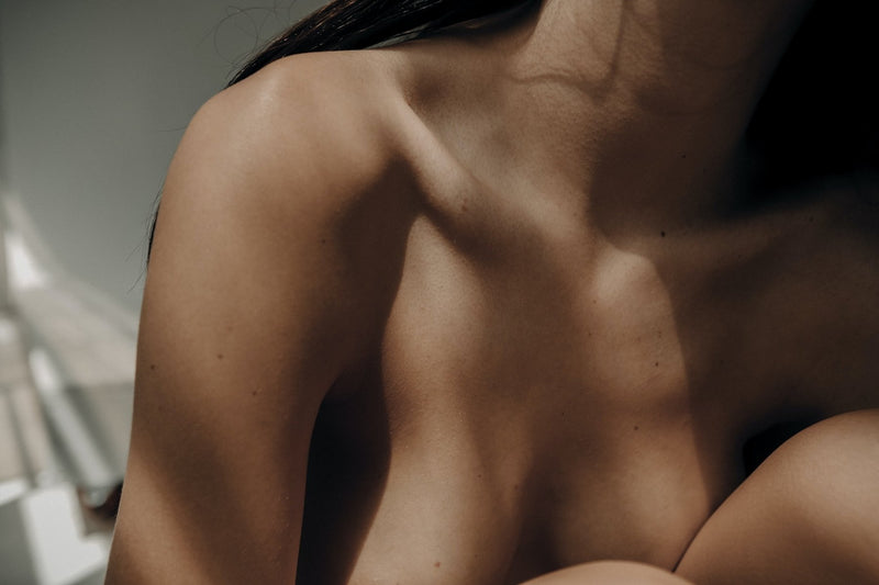 Close-up of a bare shoulder and collarbone with smooth skin
